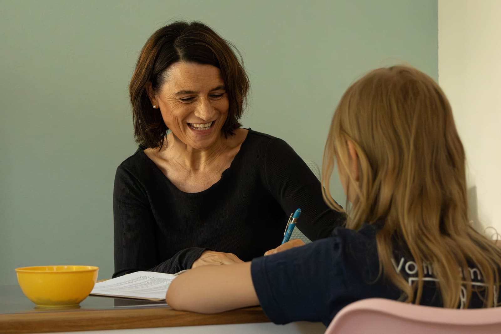 Ilona Mücke-Ozasek im Gespräch mit einem Kind am Therapietisch